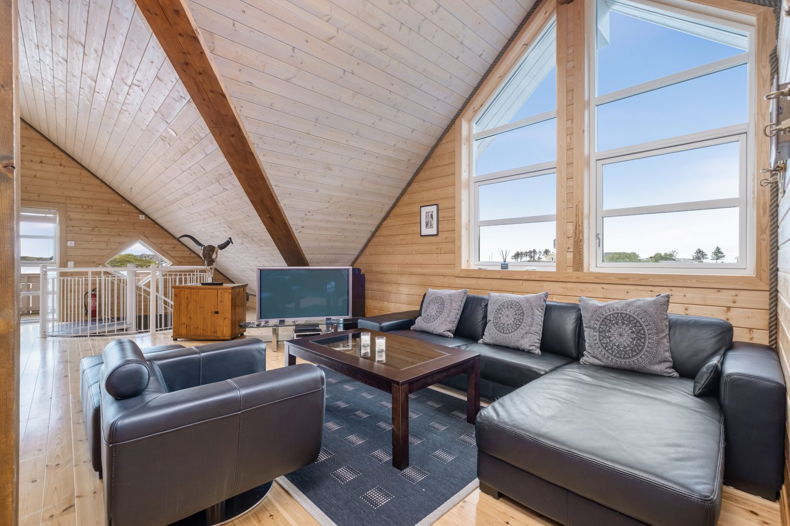Sea View — upper lounge with leather sofas and panoramic windows